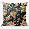 A square-shaped cushion with a maximalist floral and leaves print in vibrant colors on a dark background.