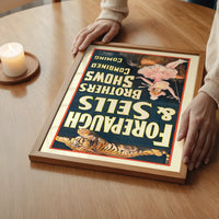 Portrait circus poster art in a bedroom, with deep blue and orange tones standing out on the wall