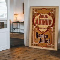 Ornate red and gold vintage Shakespeare theatre poster hanging in a hallway