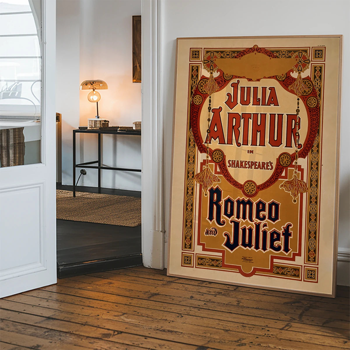 Ornate red and gold vintage Shakespeare theatre poster hanging in a hallway