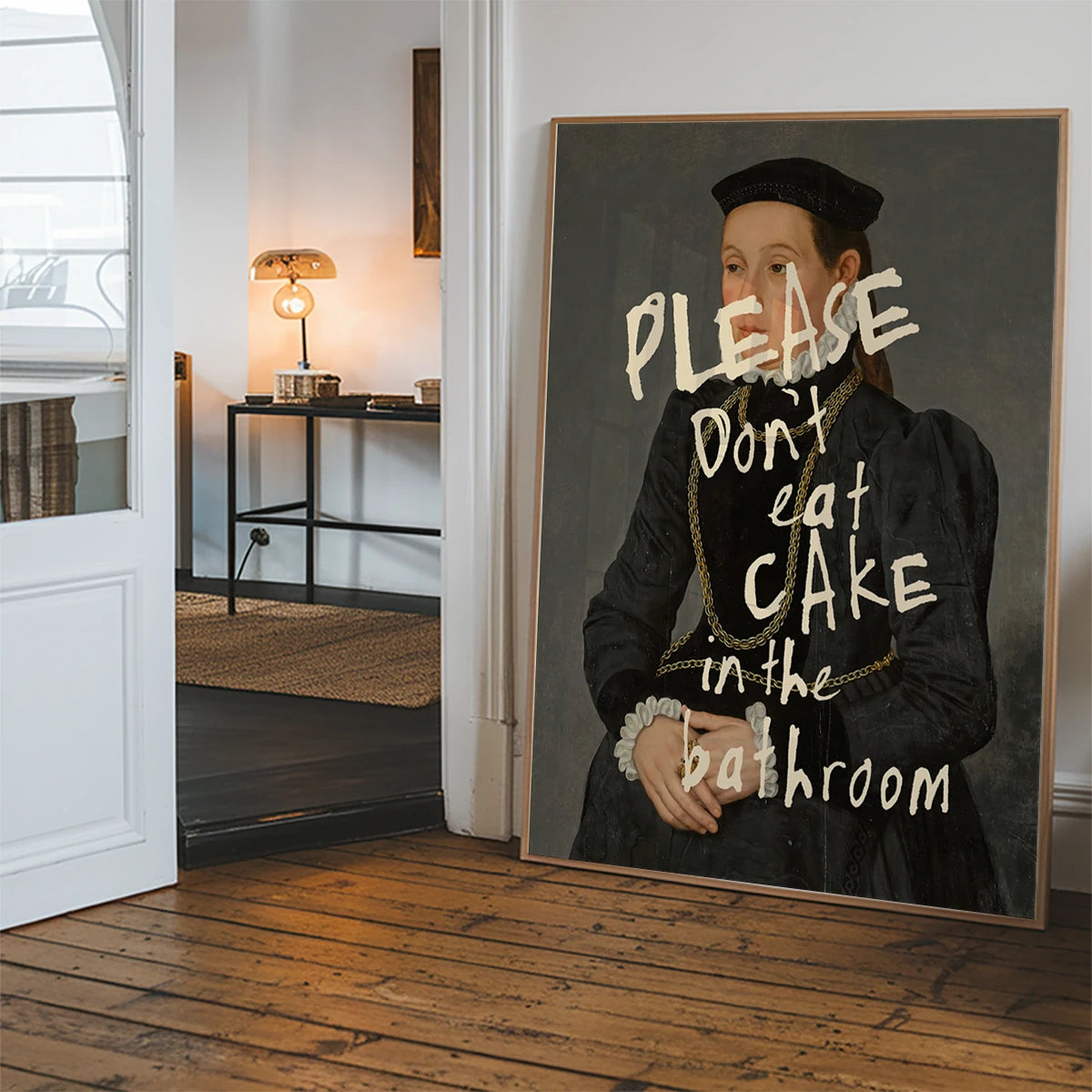 Altered portrait cake quote print hanging in a hallway