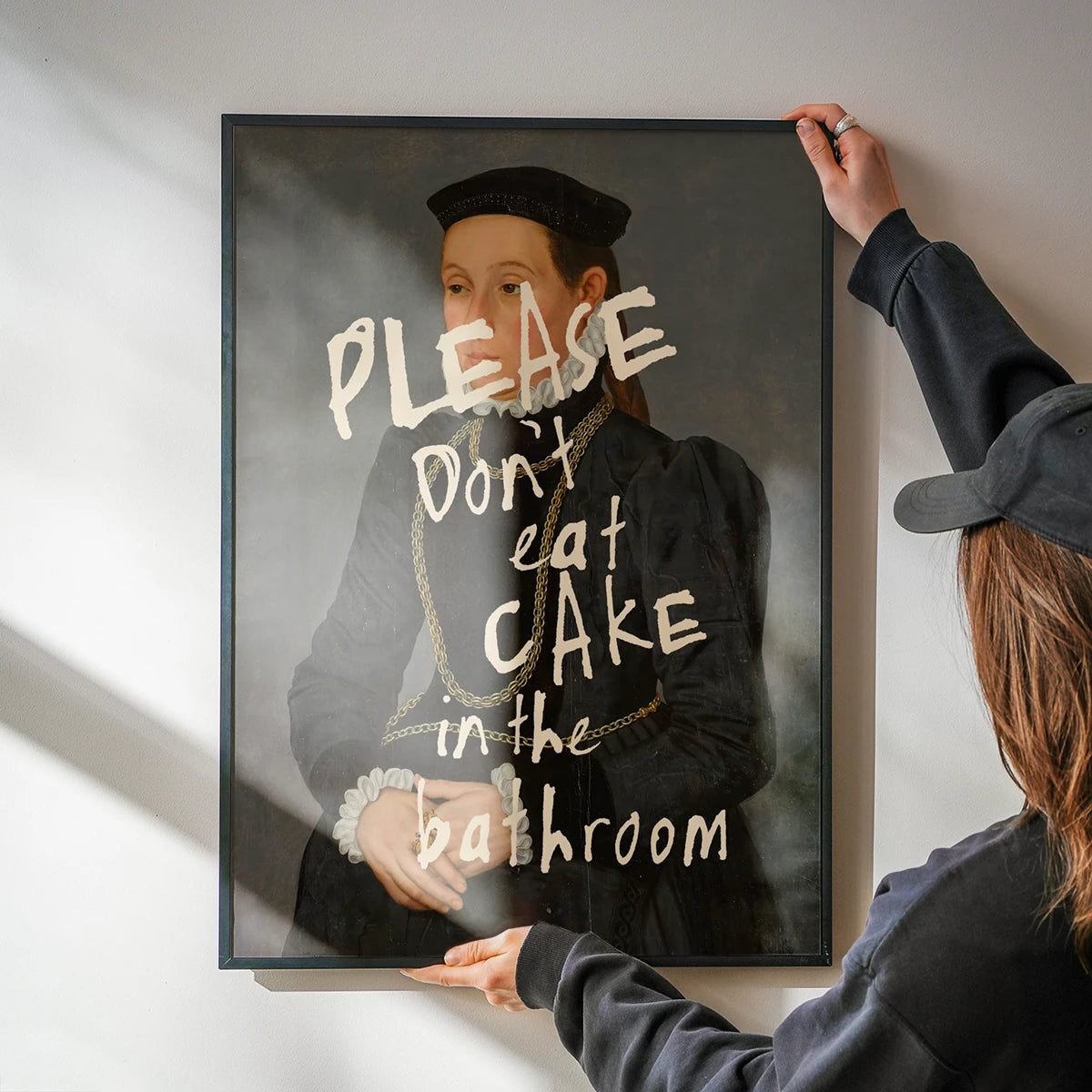 Please Don't Eat Cake in the Bathroom print on a kitchen wall