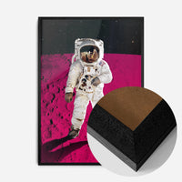 astronaut on pink moon print in a black wood frame, side profile