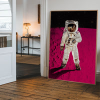 Pink Moon Astronaut portrait print hanging in a hallway, adding a pop of magenta colour