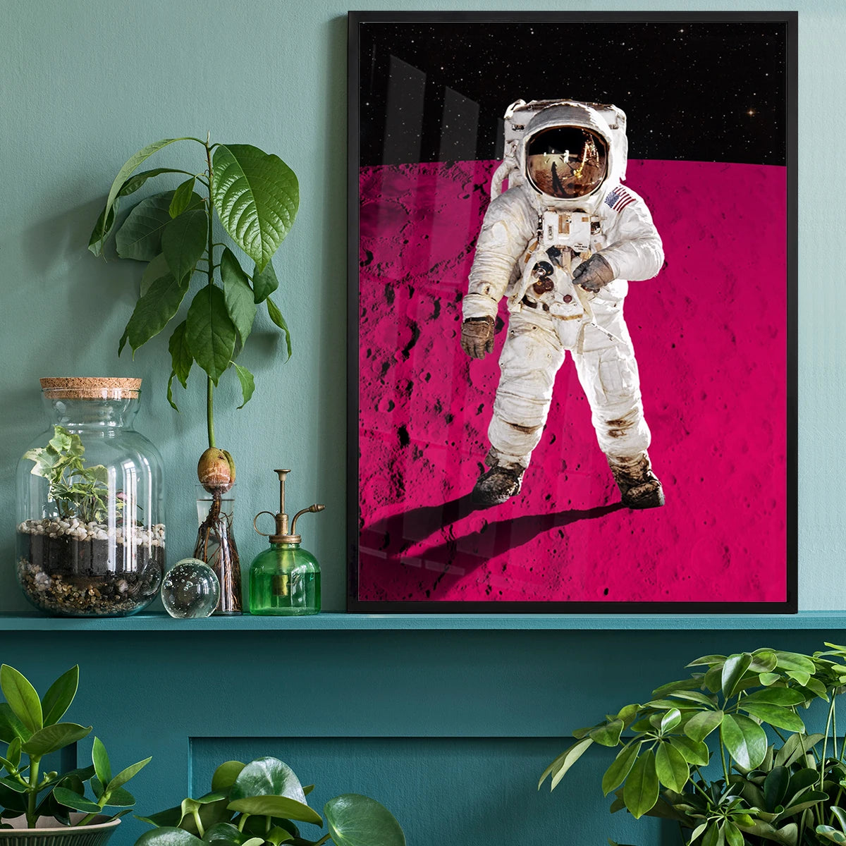 Astronaut pink moon print framed above a desk in a home office, adding creative energy