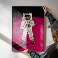 Portrait space print of an astronaut on a pink moon brightening a kitchen wall