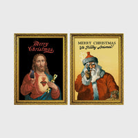 Set of 2 framed prints, festive prints: a "Merry Christmas" print with a classical Sacred Heart image; and a "Merry Christmas Ya Filthy Animal!" illustrated Santa print — unframed
