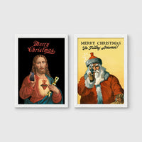 Set of 2 framed prints, festive prints: a "Merry Christmas" print with a classical Sacred Heart image; and a "Merry Christmas Ya Filthy Animal!" illustrated Santa print — unframed