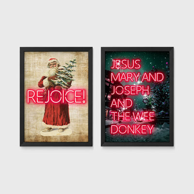Set of 2 framed prints, festive typography and illustration: a vintage Santa illustration with neon "Rejoice!" text; and neon "Jesus, Mary and Joseph and the Wee Donkey" text over a snowy tree scene — unframed