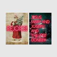 Set of 2 framed prints, festive typography and illustration: a vintage Santa illustration with neon "Rejoice!" text; and neon "Jesus, Mary and Joseph and the Wee Donkey" text over a snowy tree scene — unframed
