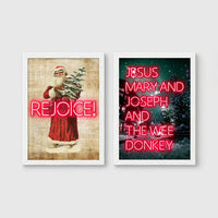 Set of 2 framed prints, festive typography and illustration: a vintage Santa illustration with neon "Rejoice!" text; and neon "Jesus, Mary and Joseph and the Wee Donkey" text over a snowy tree scene — unframed