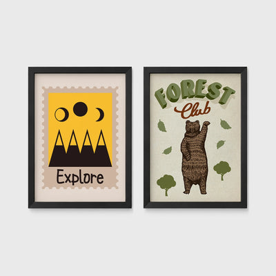 Set of 2 framed prints, stamp-style and illustrated kids prints: an "Explore" stamp-style icon illustration of mountains and moon phases; and a "Forest Club" illustration of a bear among trees — unframed