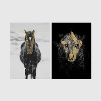 Set of 2 framed prints, animals with gold-painted highlights: a black and white horse in snow with gold-painted highlights; and a black leopard portrait with gold facial markings on black — unframed