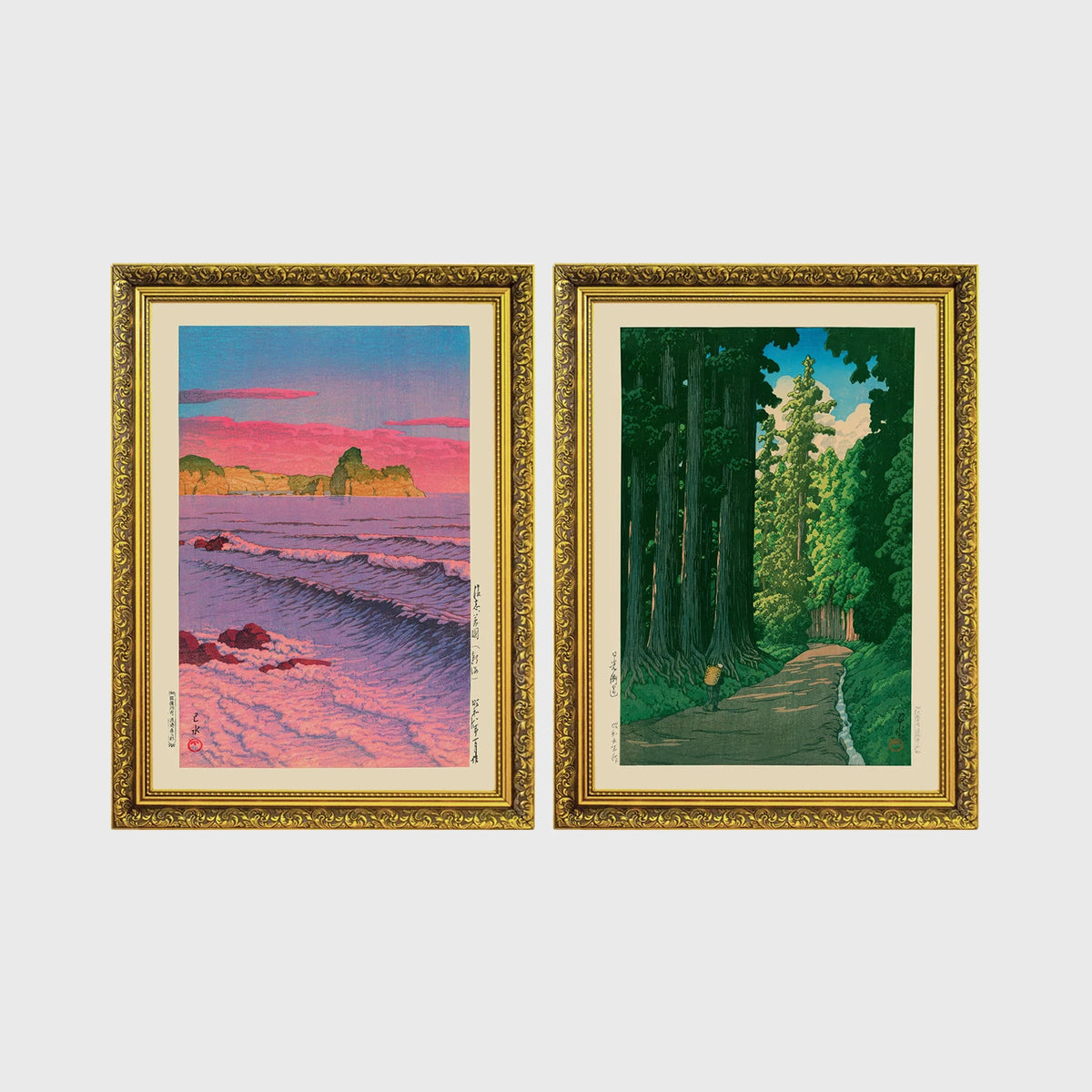 Set of 2 framed prints, Kawase Hasui Japanese woodblock prints: a pink sunset over ocean waves and cliffs; and a cedar forest path with a lone walker — unframed