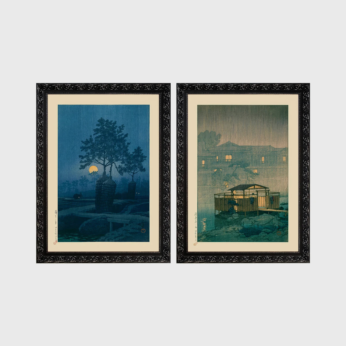 Set of 2 framed prints, Kawase Hasui Japanese woodblock prints (night scenes): a moonlit tree and stone lantern at night; and a misty rain-soaked house with lantern light at dusk — unframed