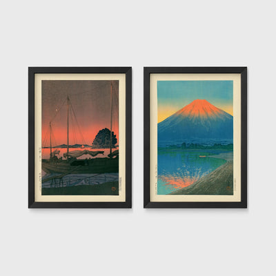 Set of 2 framed prints, Kawase Hasui Japanese woodblock prints: sailboats moored at a harbour at dusk; and Mount Fuji glowing red at sunset, reflected in the water — unframed