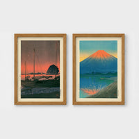 Set of 2 framed prints, Kawase Hasui Japanese woodblock prints: sailboats moored at a harbour at dusk; and Mount Fuji glowing red at sunset, reflected in the water — unframed