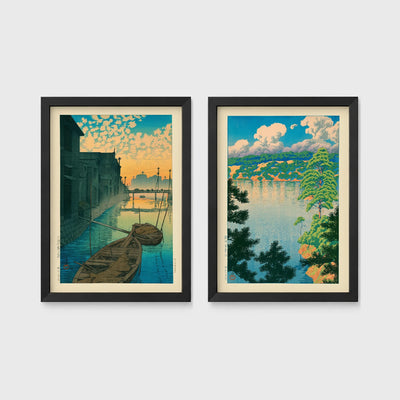 Set of 2 framed prints, Kawase Hasui Japanese woodblock prints: boats moored on a canal at dawn beneath a cloud-streaked sky; and a lake view framed by pine branches beneath drifting clouds — unframed