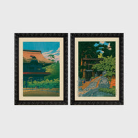 Set of 2 framed prints, Kawase Hasui Japanese woodblock prints: a temple building with a red roof against a blue sky; and a temple approach path with figures beneath trees — unframed