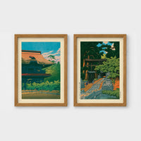 Set of 2 framed prints, Kawase Hasui Japanese woodblock prints: a temple building with a red roof against a blue sky; and a temple approach path with figures beneath trees — unframed