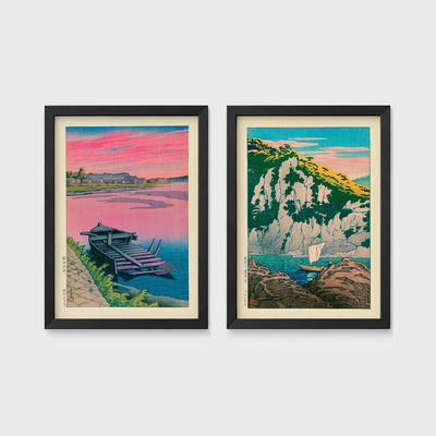 Set of 2 framed prints, Kawase Hasui Japanese woodblock prints: a pink sunset lake scene with a moored boat; and green coastal cliffs with a small sailboat — unframed