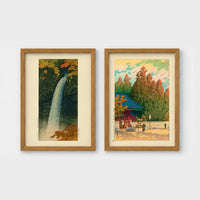 Set of 2 framed prints, Kawase Hasui Japanese woodblock prints: a waterfall cascading through autumn foliage; and a red pagoda gate in an autumn forest — unframed