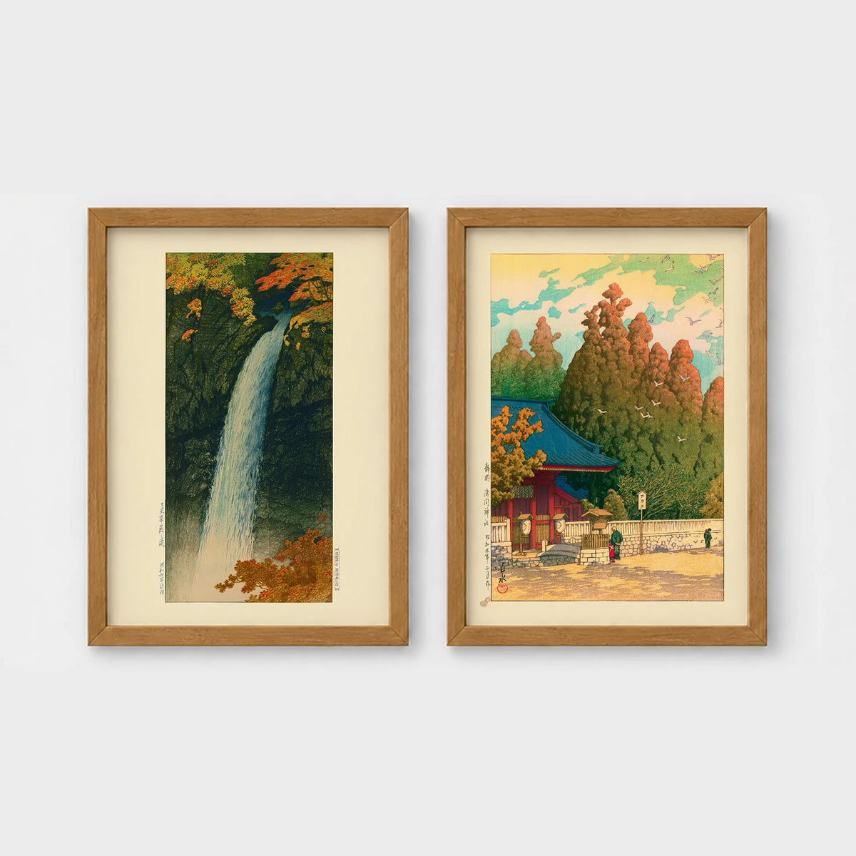 Set of 2 framed prints, Kawase Hasui Japanese woodblock prints: a waterfall cascading through autumn foliage; and a red pagoda gate in an autumn forest — unframed