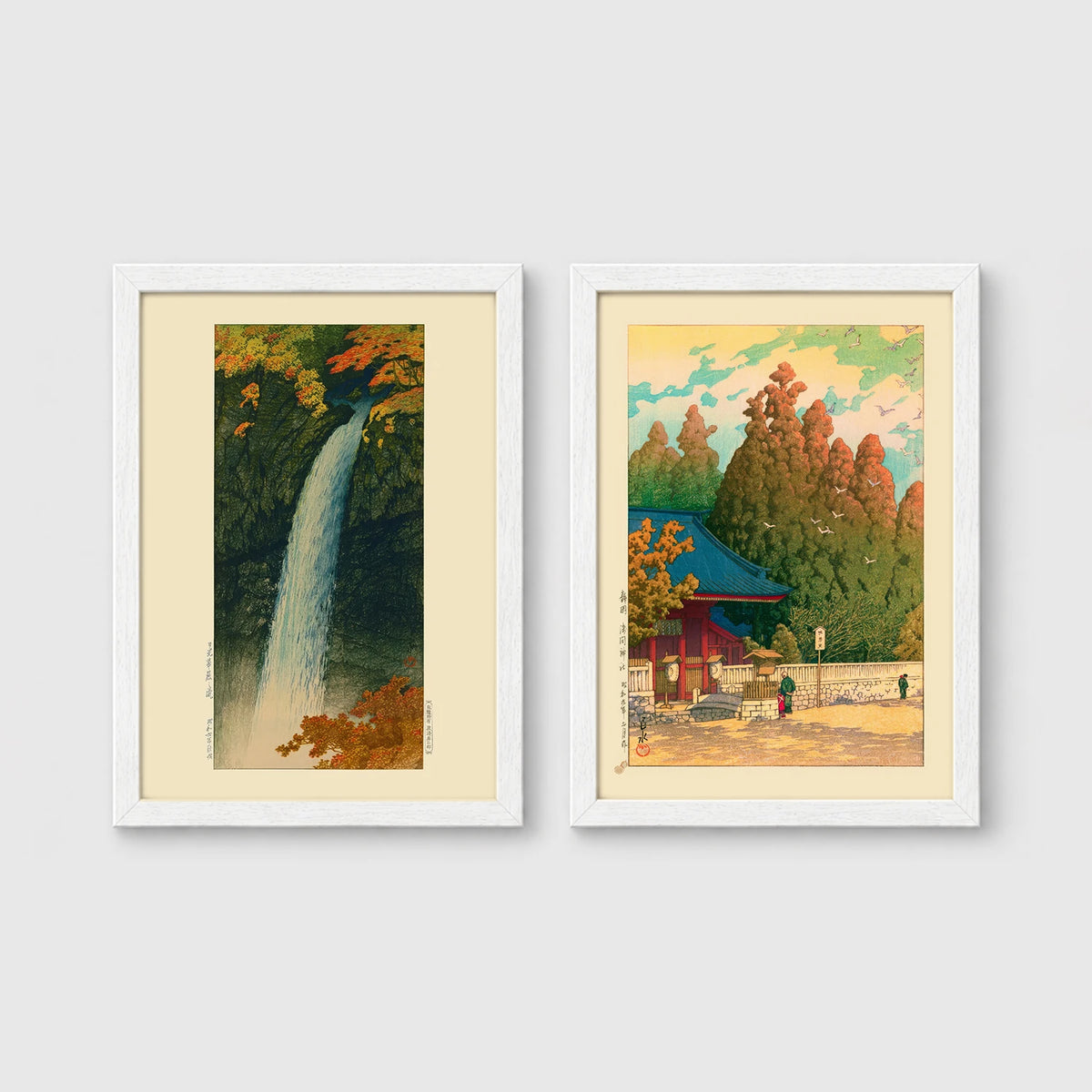 Set of 2 framed prints, Kawase Hasui Japanese woodblock prints: a waterfall cascading through autumn foliage; and a red pagoda gate in an autumn forest — unframed