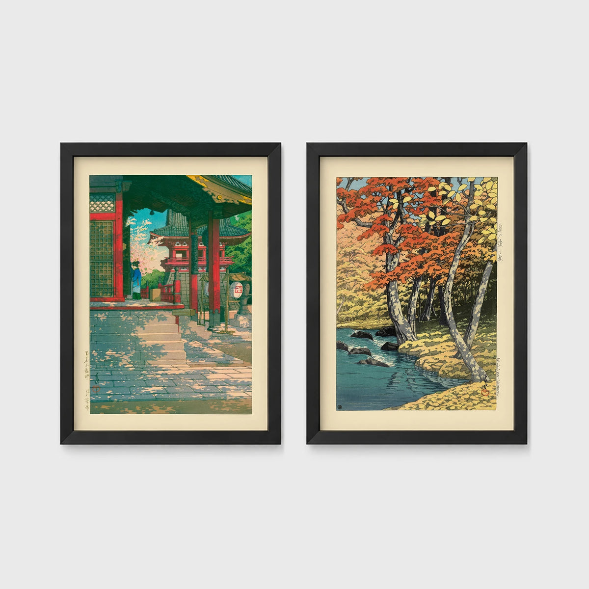 Set of 2 framed prints, Kawase Hasui Japanese woodblock prints: a red temple gate and pavilion with a figure; and a stream through autumn foliage — unframed