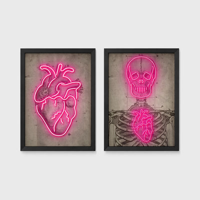 Set of 2 framed prints, neon anatomical illustrations: a neon pink anatomical heart illustration; and a neon pink skeleton skull and ribcage illustration — unframed