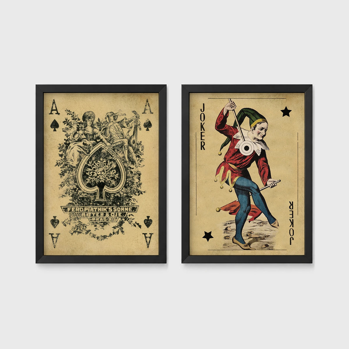 Set of 2 framed prints, vintage oversized playing cards: an ornate Ace of Spades; and a Joker — unframed