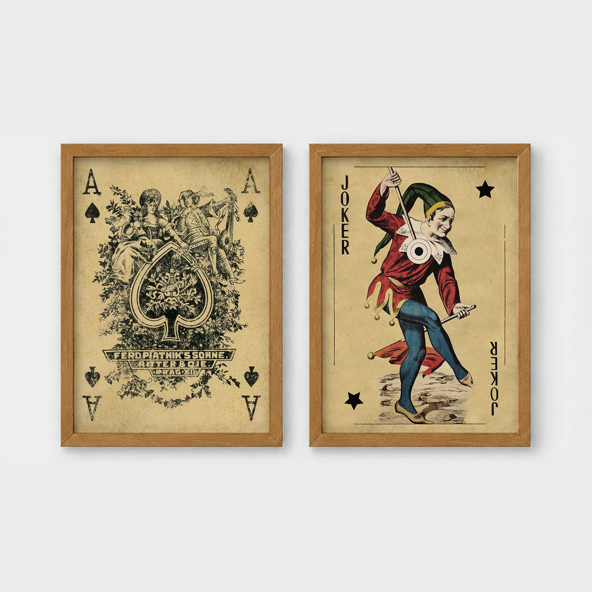 Set of 2 framed prints, vintage oversized playing cards: an ornate Ace of Spades; and a Joker — unframed