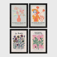 Set of 4 framed prints, pop art and vintage-poster mix: a Warhol-style pop art skull in orange on blue; an "L'atelier des Fleurs" floral botanical poster; a "Welcome To The Freak Show" vintage floral circus poster; and a still life with a skull and jar, overlaid with colourful polka dots — unframed