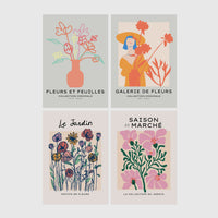 Set of 4 framed prints, pop art and vintage-poster mix: a Warhol-style pop art skull in orange on blue; an "L'atelier des Fleurs" floral botanical poster; a "Welcome To The Freak Show" vintage floral circus poster; and a still life with a skull and jar, overlaid with colourful polka dots — unframed