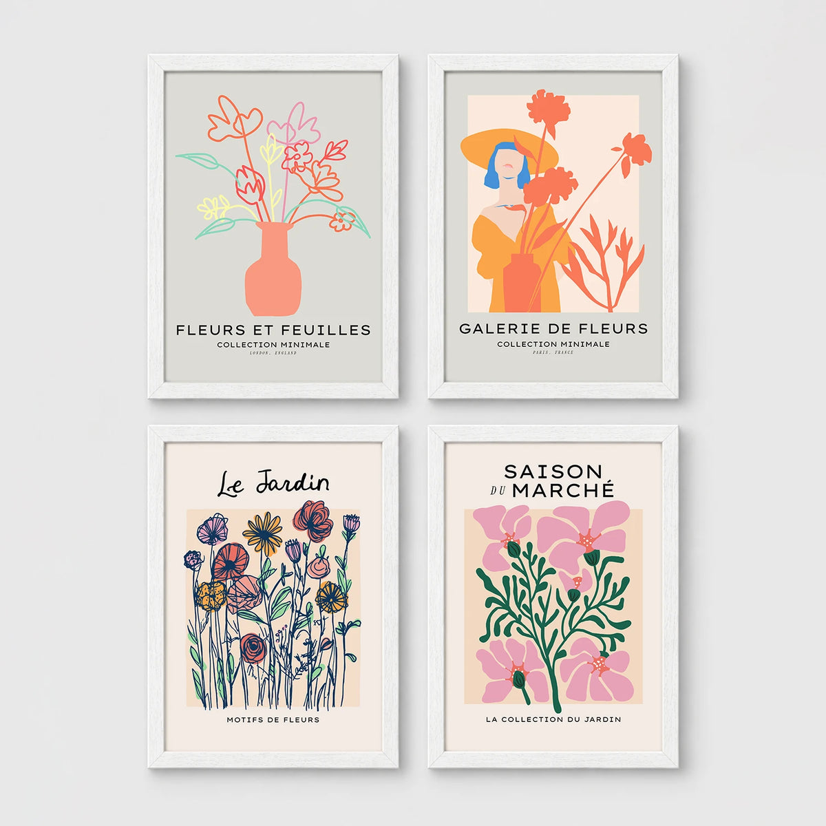 Set of 4 framed prints, pop art and vintage-poster mix: a Warhol-style pop art skull in orange on blue; an "L'atelier des Fleurs" floral botanical poster; a "Welcome To The Freak Show" vintage floral circus poster; and a still life with a skull and jar, overlaid with colourful polka dots — unframed