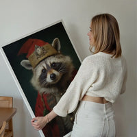 Woman holding a large Christmas racoon animal portrait print in a red costume and gold hat.