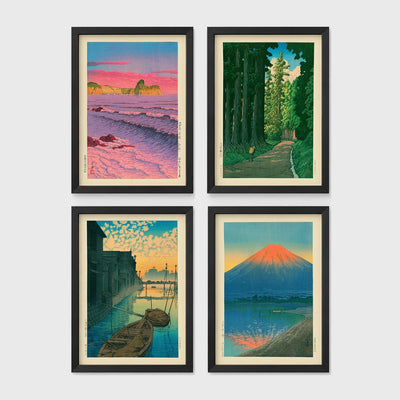 Set of 4 framed prints, Kawase Hasui Japanese woodblock prints: pink sunset over ocean waves and cliffs; a cedar forest path with a lone walker; boats moored on a canal at dawn beneath a cloud-streaked sky; and Mount Fuji glowing red at sunset, reflected in the water — unframed