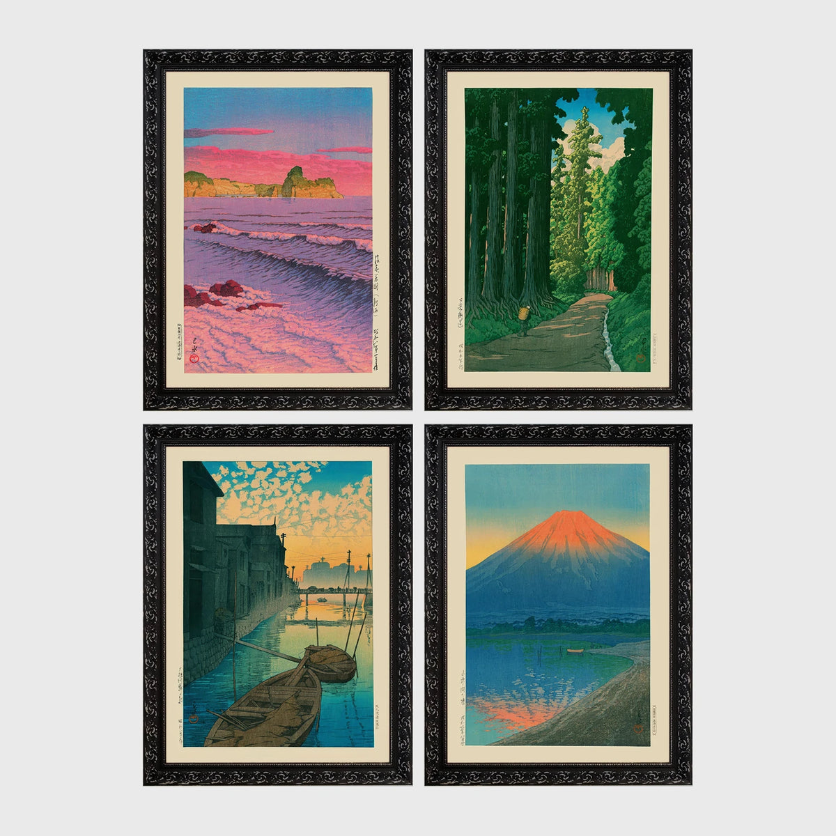 Set of 4 framed prints, Kawase Hasui Japanese woodblock prints: pink sunset over ocean waves and cliffs; a cedar forest path with a lone walker; boats moored on a canal at dawn beneath a cloud-streaked sky; and Mount Fuji glowing red at sunset, reflected in the water — unframed
