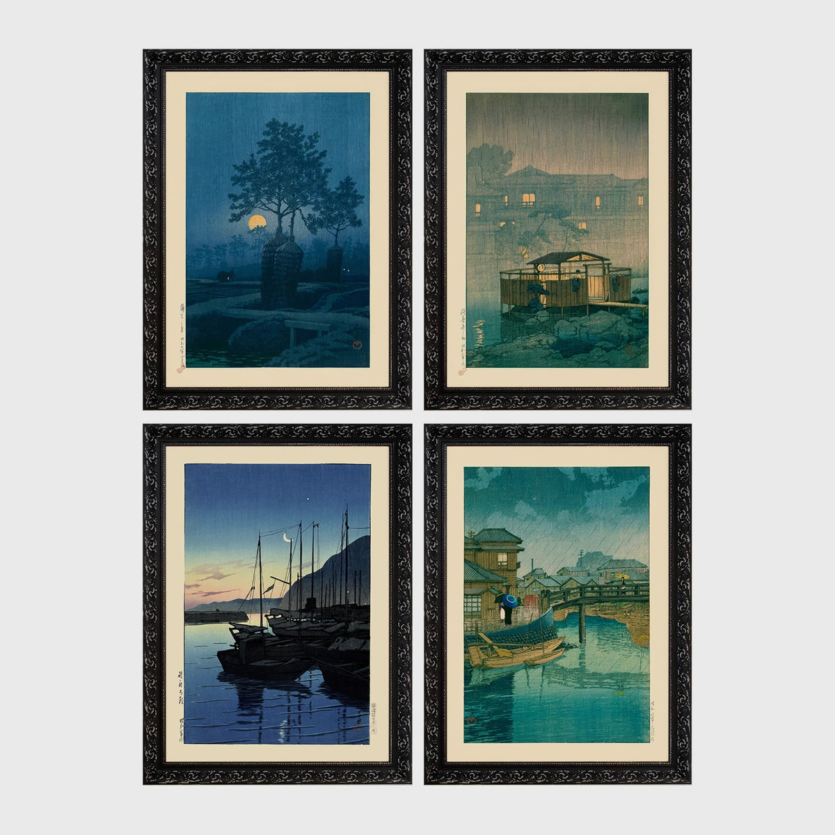 Set of 4 framed prints, Kawase Hasui Japanese woodblock prints (night scenes): a moonlit tree and stone lantern at night; a misty rain-soaked house with lantern light at dusk; sailboats moored at a harbour at dawn; and a canal bridge scene with a figure and umbrella at twilight — unframed