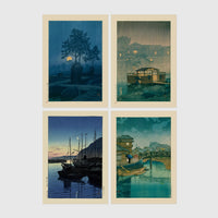 Set of 4 framed prints, Kawase Hasui Japanese woodblock prints (night scenes): a moonlit tree and stone lantern at night; a misty rain-soaked house with lantern light at dusk; sailboats moored at a harbour at dawn; and a canal bridge scene with a figure and umbrella at twilight — unframed