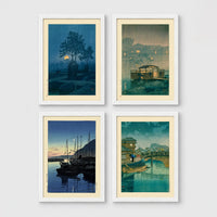 Set of 4 framed prints, Kawase Hasui Japanese woodblock prints (night scenes): a moonlit tree and stone lantern at night; a misty rain-soaked house with lantern light at dusk; sailboats moored at a harbour at dawn; and a canal bridge scene with a figure and umbrella at twilight — unframed