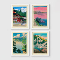 Set of 4 framed prints, Kawase Hasui Japanese woodblock prints: a red shrine framed by pine trees under a blue sky; a pink sunset over a lake with a moored boat; a lake view framed by pine branches beneath drifting clouds; and green coastal cliffs with a waterfall over turquoise water — unframed