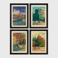 Set of 4 framed prints, Kawase Hasui Japanese woodblock prints (landmarks): a red arched bridge beneath cascading wisteria and cherry blossom; the Great Buddha of Kamakura among pine trees; a stream through autumn foliage; and a red pagoda gate in an autumn forest — unframed