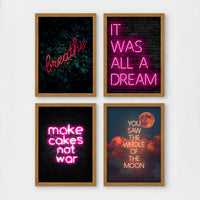 Set of 4 framed prints, pink typographic quote prints: "Let's Stay Home" bold retro typography; a peace-sign hand illustration filled with uplifting text; "This Kitchen Is For Dancing" bold retro typography; and a second peace-sign hand illustration filled with uplifting text — unframed