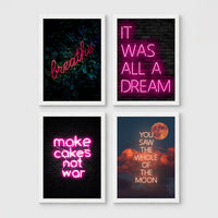 Set of 4 framed prints, pink typographic quote prints: "Let's Stay Home" bold retro typography; a peace-sign hand illustration filled with uplifting text; "This Kitchen Is For Dancing" bold retro typography; and a second peace-sign hand illustration filled with uplifting text — unframed