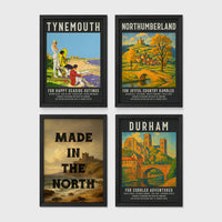 Set of 4 framed prints, vintage North East England travel posters: a "Tynemouth - For Happy Seaside Outings" vintage travel poster; a "Northumberland - For Joyful Country Rambles" vintage travel poster; "Made in the North" over a coastal castle landscape; and a "Durham - For Cobbled Adventures" vintage travel poster — unframed