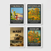 Set of 4 framed prints, vintage North East England travel posters: a "Tynemouth - For Happy Seaside Outings" vintage travel poster; a "Northumberland - For Joyful Country Rambles" vintage travel poster; "Made in the North" over a coastal castle landscape; and a "Durham - For Cobbled Adventures" vintage travel poster — unframed