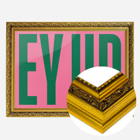 bold pink green typography print in a gold ornate frame, side profile