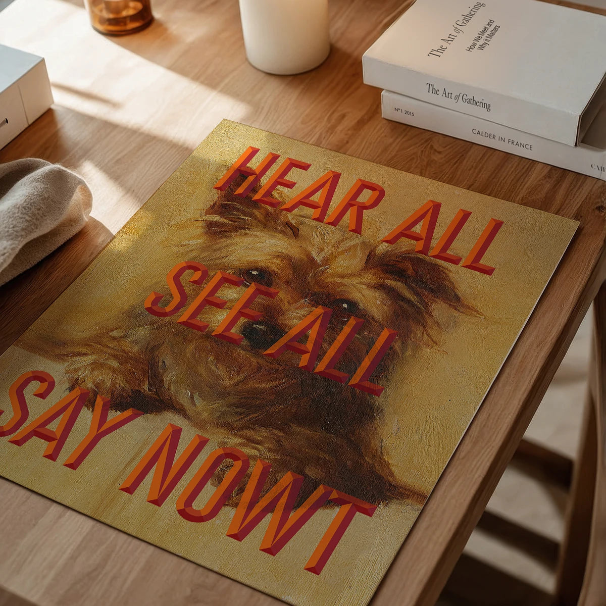 Say Nowt print in a dining room, painted terrier with bold orange lettering