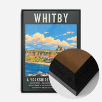 Whitby harbour travel poster print in a black wood frame, side profile